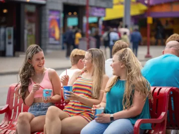 Kids sitting on a bench on Clifton Hill eating Dairy Queen